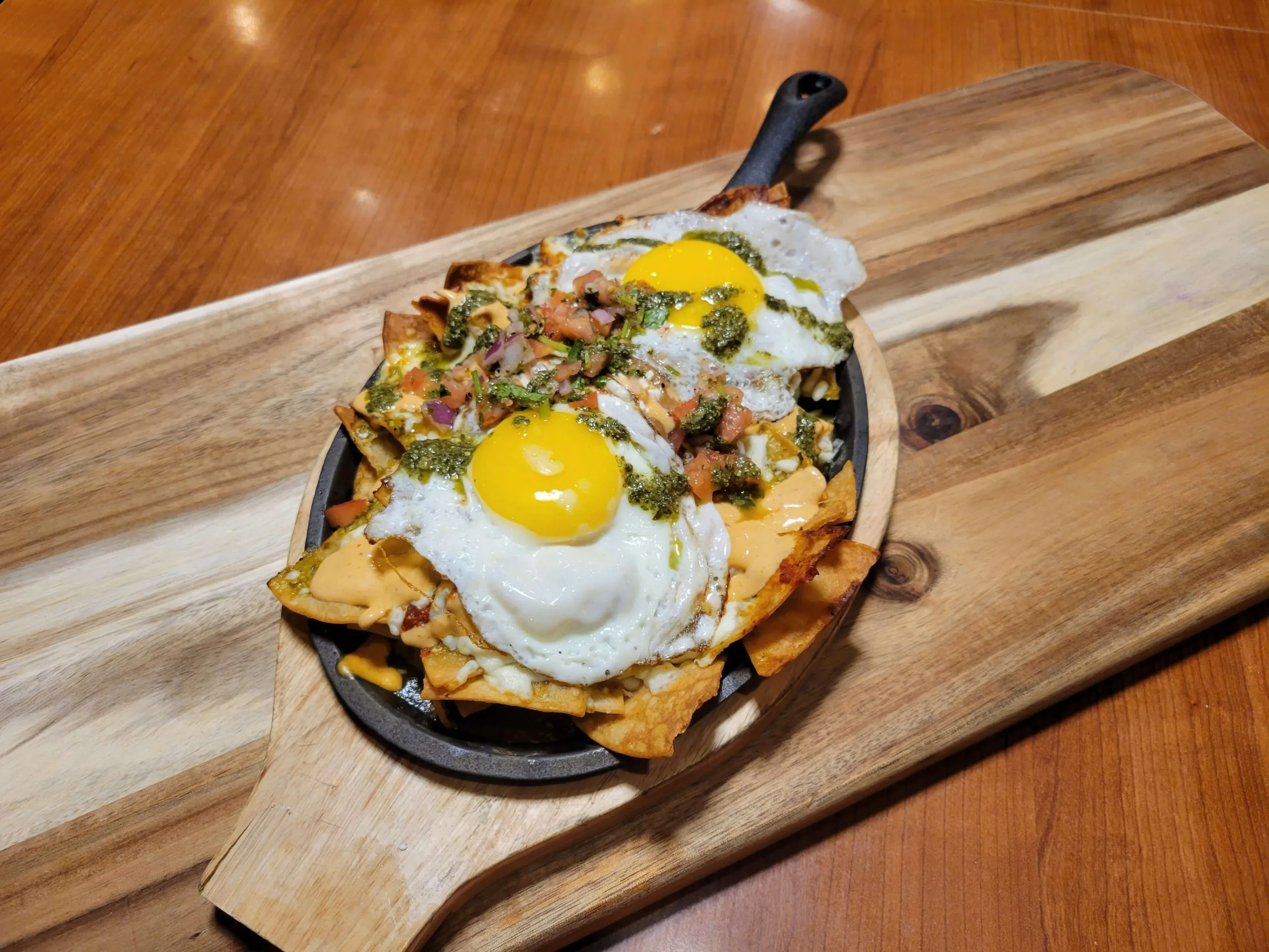 Loaded brunch plate topped with fresh eggs at Maison Croissant & Bowls in St. Vital, Winnipeg